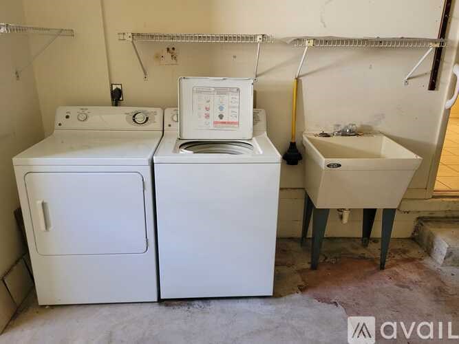 A white washing machine and dryer in a small laundry room.