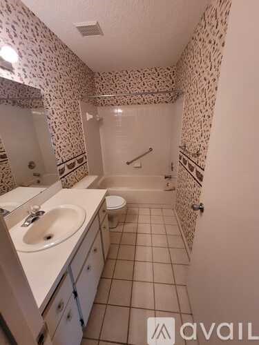A bathroom with a sink, toilet, and shower.