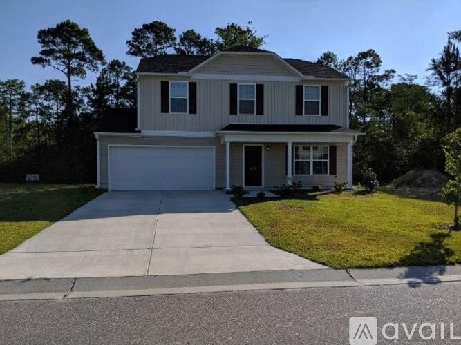 A house with a garage is for sale.