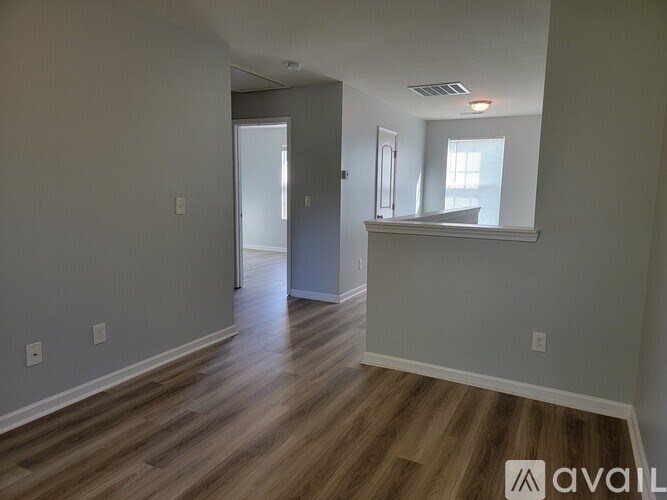 A room with wooden floors and a white door.