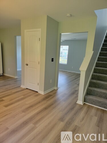 A room with a staircase and a door.