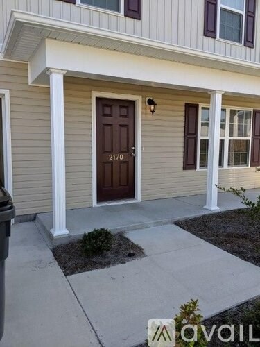 A house with a brown door and a number 2170 on it.