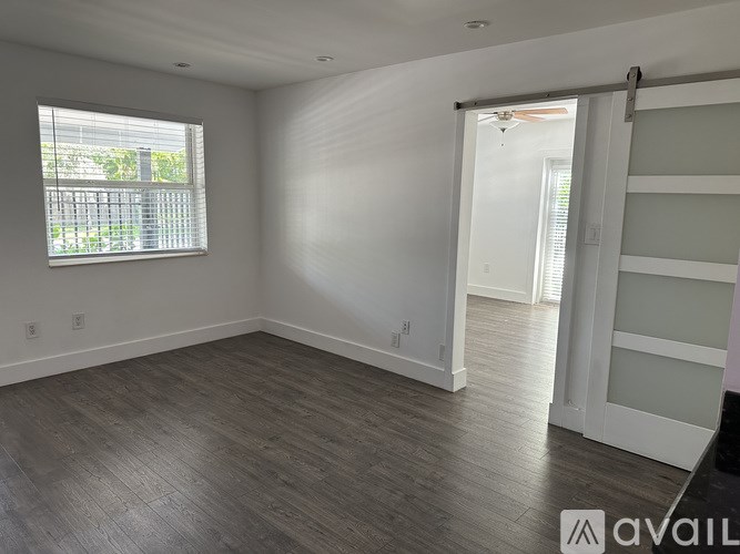 A room with a sliding door and a window with blinds.