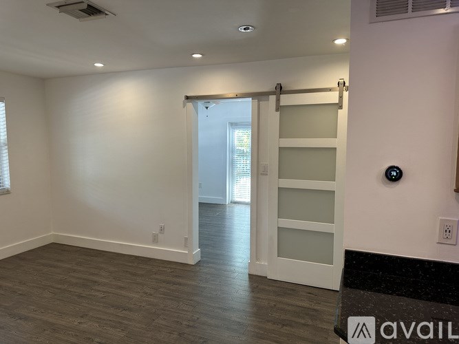 A room with a sliding door and a ceiling fan.