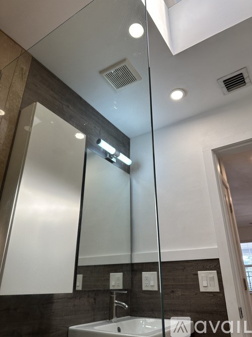 A bathroom with a sink and mirror.