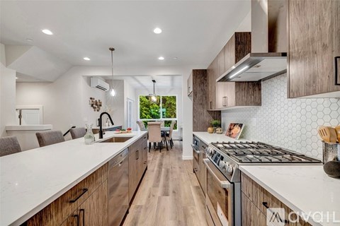 A modern kitchen with wooden cabinets and a large island.