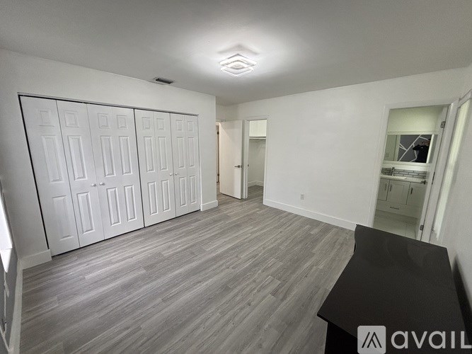 A room with a long table and a row of cupboards.