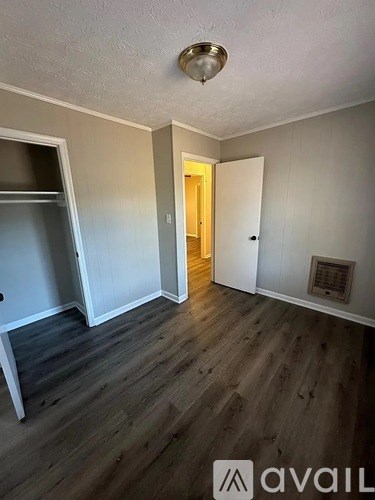 A room with wooden floors and a white door.