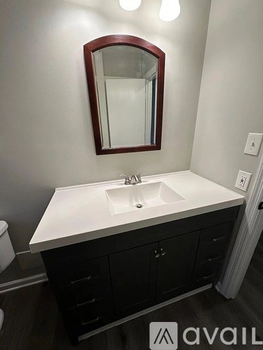 A bathroom with a sink and a mirror.