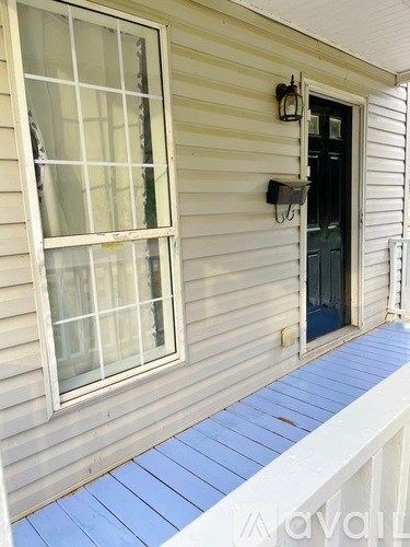 A house with a blue wooden porch.