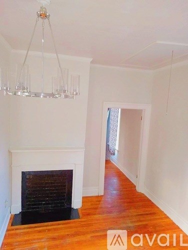 A room with a fireplace and a chandelier.
