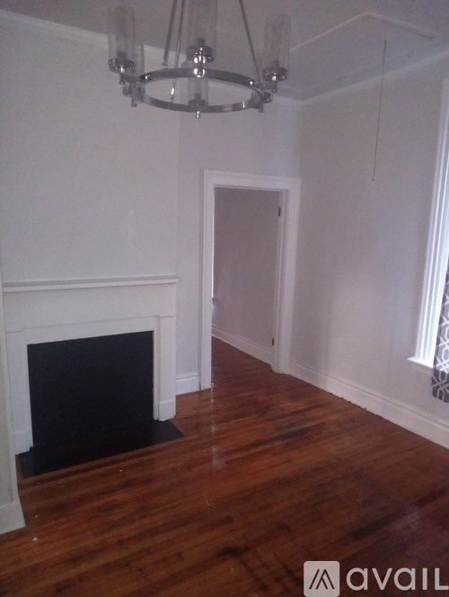 A room with a fireplace and a chandelier.