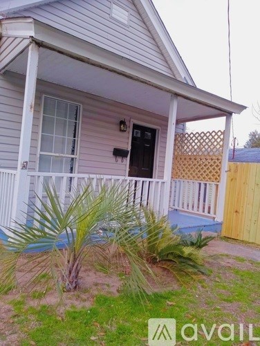 A house with a porch and a fence.