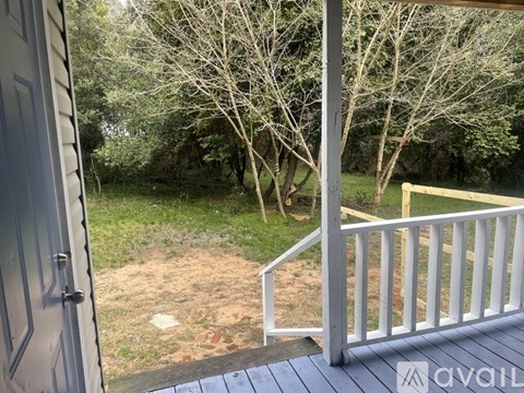 A view from a deck looking out to a backyard with trees.