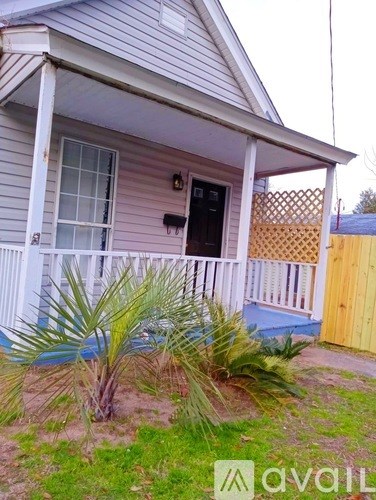 A house with a porch and a fence.
