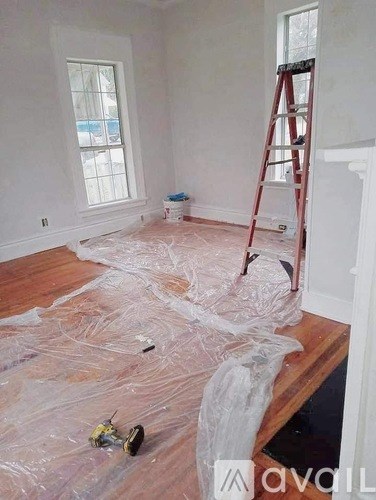 A room with a ladder and a window.