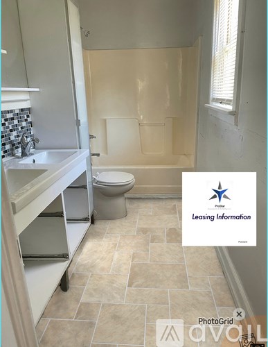 A bathroom with a toilet, sink, and bathtub.