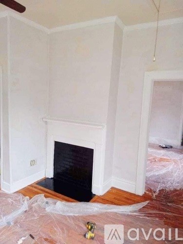 A room with a fireplace and a ceiling fan.