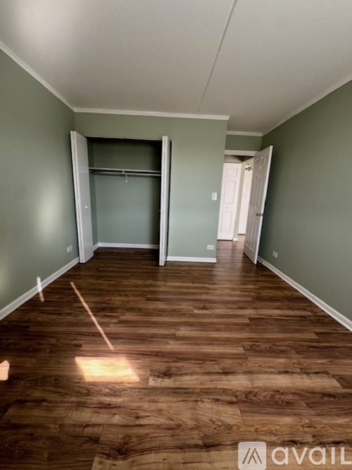 A room with wooden flooring and a sliding glass door.