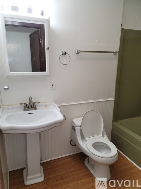A white sink and toilet in a small bathroom.