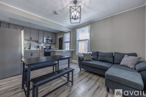 A kitchen with a table and a couch in the living room.