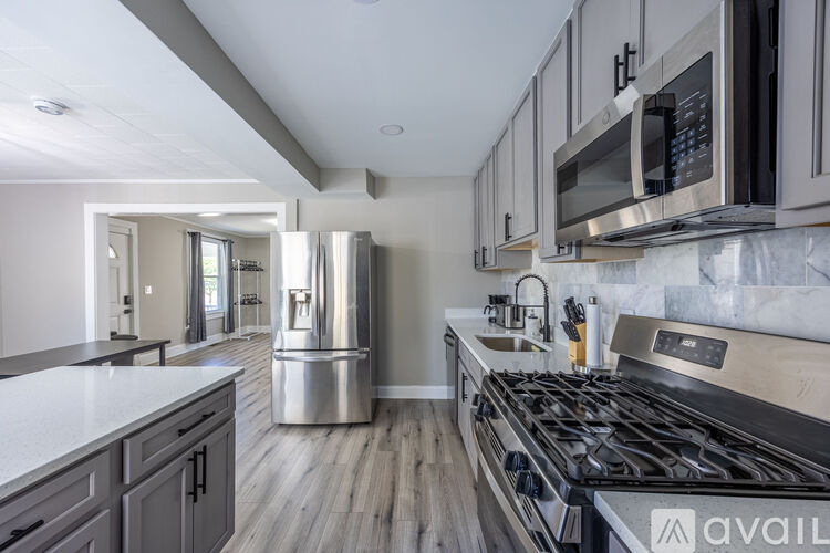 A modern kitchen with a stainless steel refrigerator and a stainless steel stove.