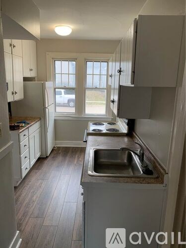 A kitchen with a sink and a window.