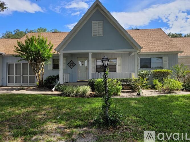 A house with a front yard and a lamp post.
