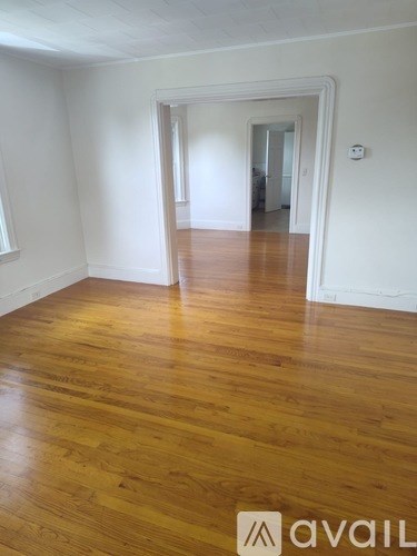 A room with wooden floors and white walls.