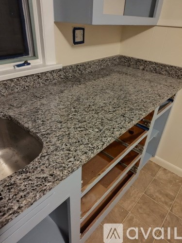 A kitchen counter with a sink and a window.