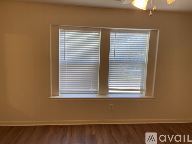 A room with a window covered in blinds.