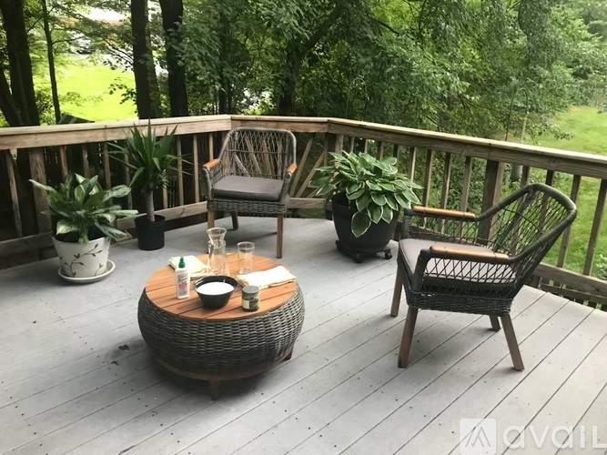 A wooden deck with a table and chairs.