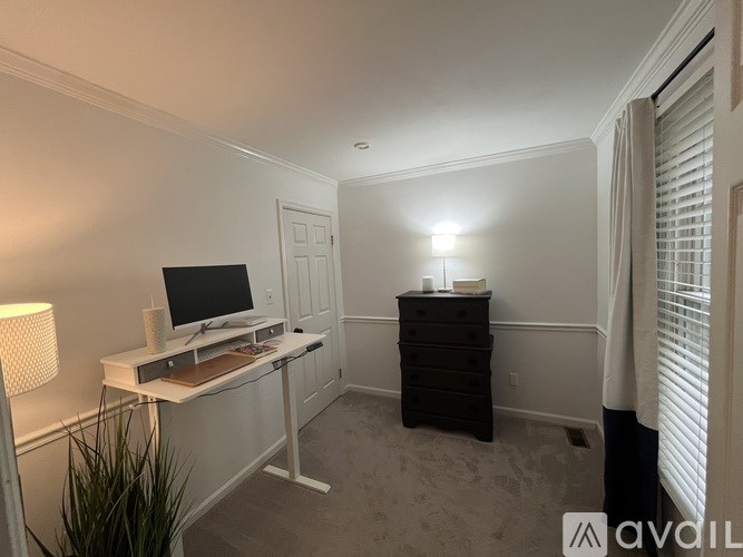 A room with a desk and a computer on it.