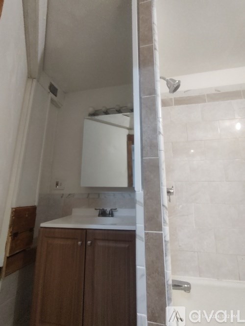 A bathroom with a sink and mirror.