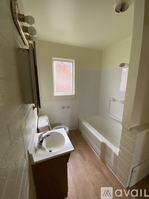 A bathroom with a sink, toilet, and bathtub.