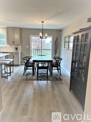 A dining room with a table set for six.