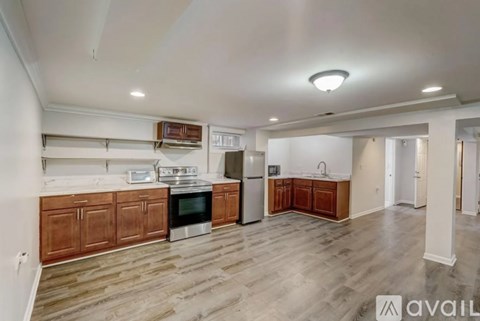 A kitchen with wooden cabinets and a white fridge.