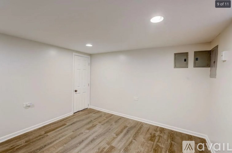 A room with a white door and a window with blinds.