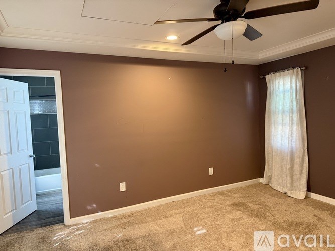 A room with brown walls and a ceiling fan.