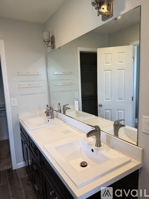 A bathroom with a white sink and a mirror.