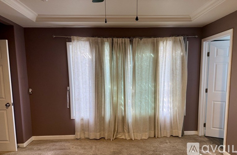 A room with a brown wall and a white door.