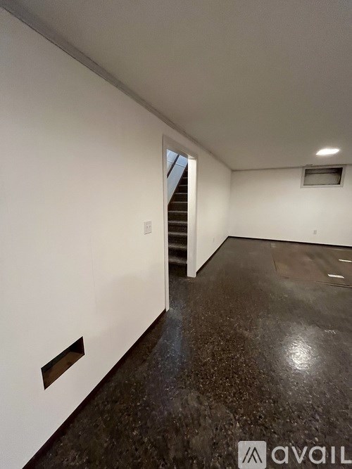 A room with a staircase leading to another floor.