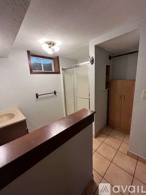 A bathroom with a toilet, sink, and shower.