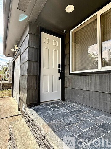 A white door is on the right side of a house.