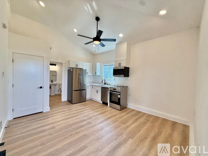 A spacious kitchen with a refrigerator, oven, and microwave.
