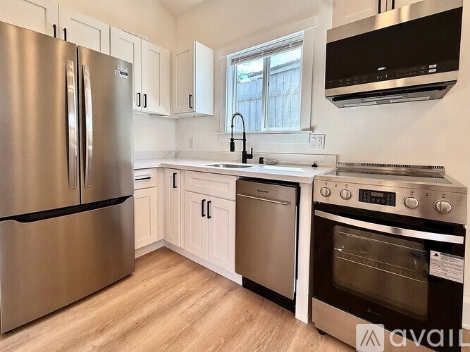 A kitchen with a stainless steel refrigerator and oven.