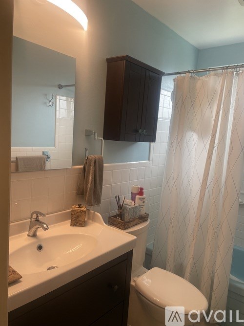 A bathroom with a white sink and a white toilet.