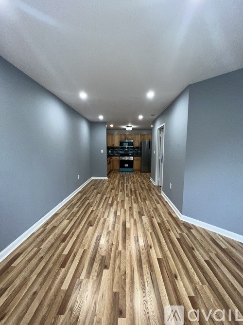 A room with wooden flooring and a white ceiling.