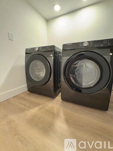 Two front load washing machines in a room.