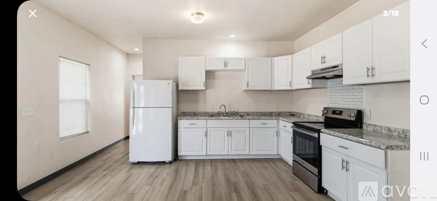 A kitchen with white appliances and cabinets.